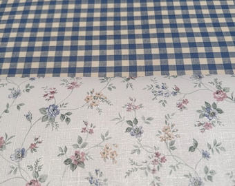 May include: Two pieces of fabric, one with a blue and white gingham pattern and the other with a white background and a small floral pattern.