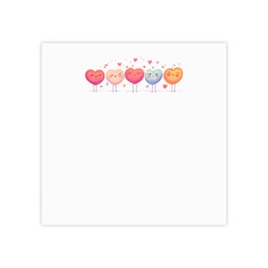 May include: A white square print featuring six cartoon hearts in various colors, each with small legs and arms. The hearts are pink, peach, red, blue, and orange, with small hearts floating above them.
