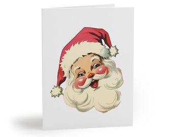 Può includere: Un biglietto di auguri bianco piegato con un'illustrazione vintage di Babbo Natale. Babbo Natale è raffigurato con un cappello rosso, guance rosee e barba bianca. Il biglietto è vuoto all'interno, pronto per un messaggio personalizzato.