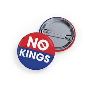 May include: Two round buttons with a pin back. One button is red and blue with the words "NO KINGS" in white. The other button is red and blue with a silver pin back.