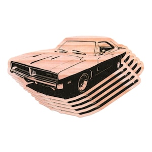 May include: Wooden car-shaped coasters featuring a classic Dodge Charger design. The coasters are made of light-colored wood with a black outline of the car. The coasters are stacked on top of each other.