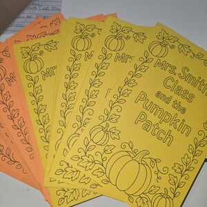 May include: A stack of yellow and orange paper sheets with black line art of pumpkins and leaves. The text "Mrs. Smith Class and the Pumpkin Patch" is visible on the yellow sheets. The sheets are likely for a fall-themed activity.