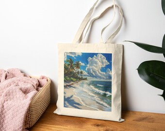 May include: A cream-coloured tote bag displaying a beach scene. The image shows a white sandy beach, turquoise water, palm trees, and a bright blue sky with fluffy white clouds. The bag has long handles and a simple design.