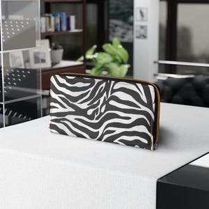 Cartera moderna con cremallera y estampado de cebra para mujer: elegante clutch con estampado animal y amplios compartimentos para tus objetos de uso diario.