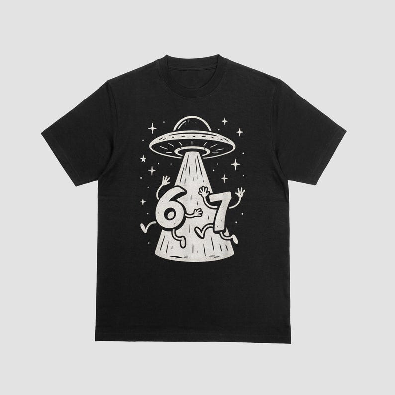 May include: Black t-shirt featuring a whimsical illustration of a UFO beaming up the numbers 6 and 7. The numbers have arms and legs, with a starry background. The design is in a vintage, hand-drawn style.