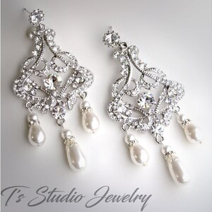 May include: Silver chandelier earrings with crystal accents and pearl drops.