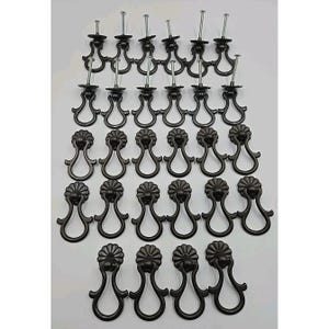 May include: A collection of black metal drawer pulls with a decorative floral design. Each pull has a curved handle and a screw for installation. The pulls are arranged in neat rows, suggesting a set for multiple drawers or cabinets.