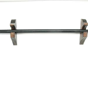 May include: A black wooden baton with a white tip, displayed on two brown wooden supports. The baton is long and cylindrical, and the supports are angled. The background is plain white.