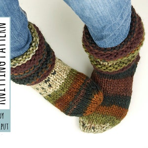 May include: Striped knitted socks in shades of brown, green, and beige. The socks have a folded cuff and are worn over blue jeans. The text "LADY LILLIPUT KNITTING PATTERN" is visible on the left side of the image.
