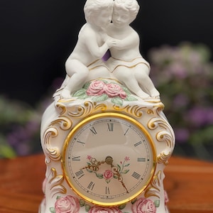 1987 Franklin Mint “The First Embrace” Porcelain Clock | Romantic Cherub Figurine | Hand-Painted Rose Decor | Mantel Clock Collectible