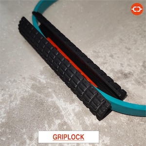 May include: A close-up shot of a black GripLock device with a textured surface, an orange interior, and a teal ring. The word "GRIPLOCK" is displayed in a white rectangle at the bottom of the image.