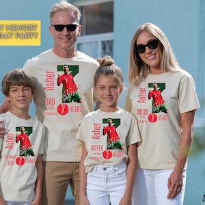 May include: A family of five wearing matching beige t-shirts with a soccer player graphic. Each shirt has the name "Asher" and the text "7 Years". The shirts are for the "Dad", "Mom", "Sister", and "Birthday Boy". The words "Family Memory Birthday Party" are in a yellow box.