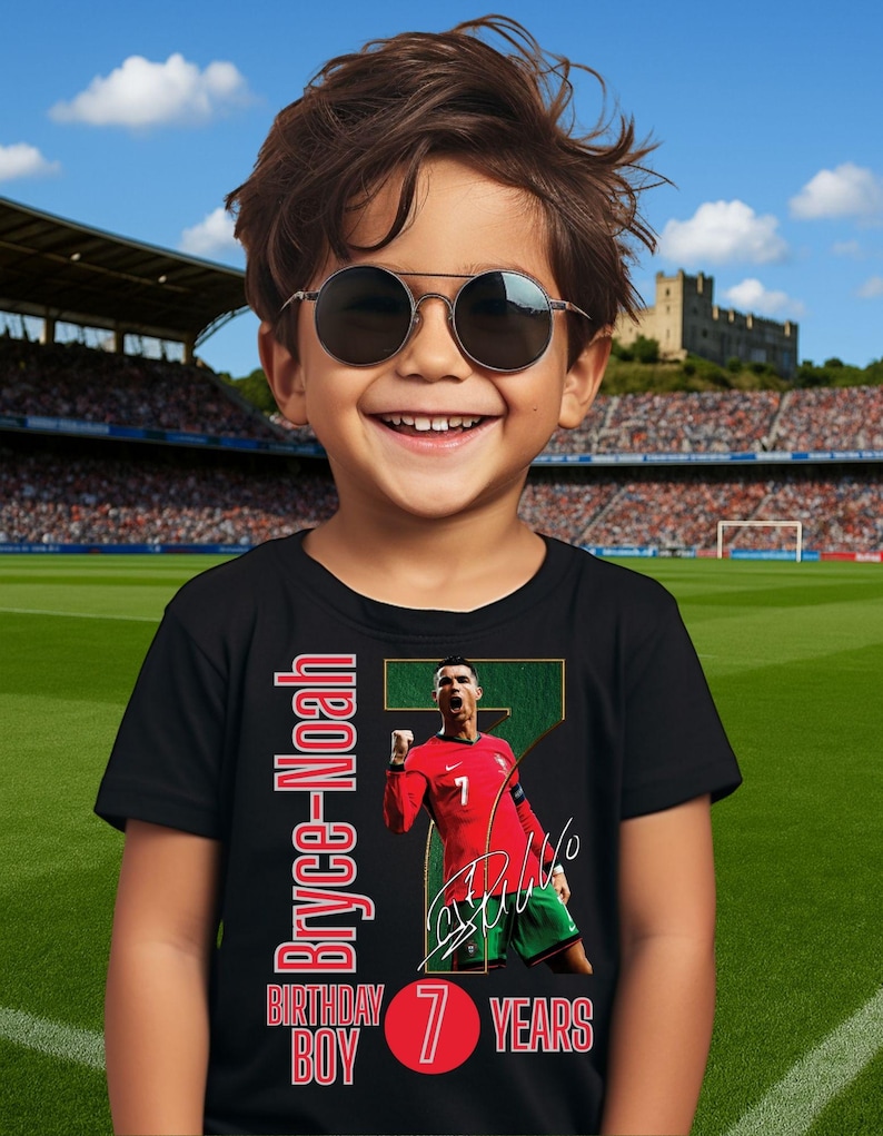 May include: A black t-shirt featuring a soccer player in a red jersey with the number 7. The shirt has the text "Bryce-Noah" and "Birthday Boy 7 Years" in red. The boy in the image is wearing sunglasses and smiling.