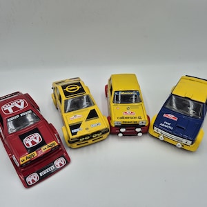 Vintage collection of 3 Burago and 1 Polistil model cars. All in good condition, some minor wear marks and some stickers starting to peel.