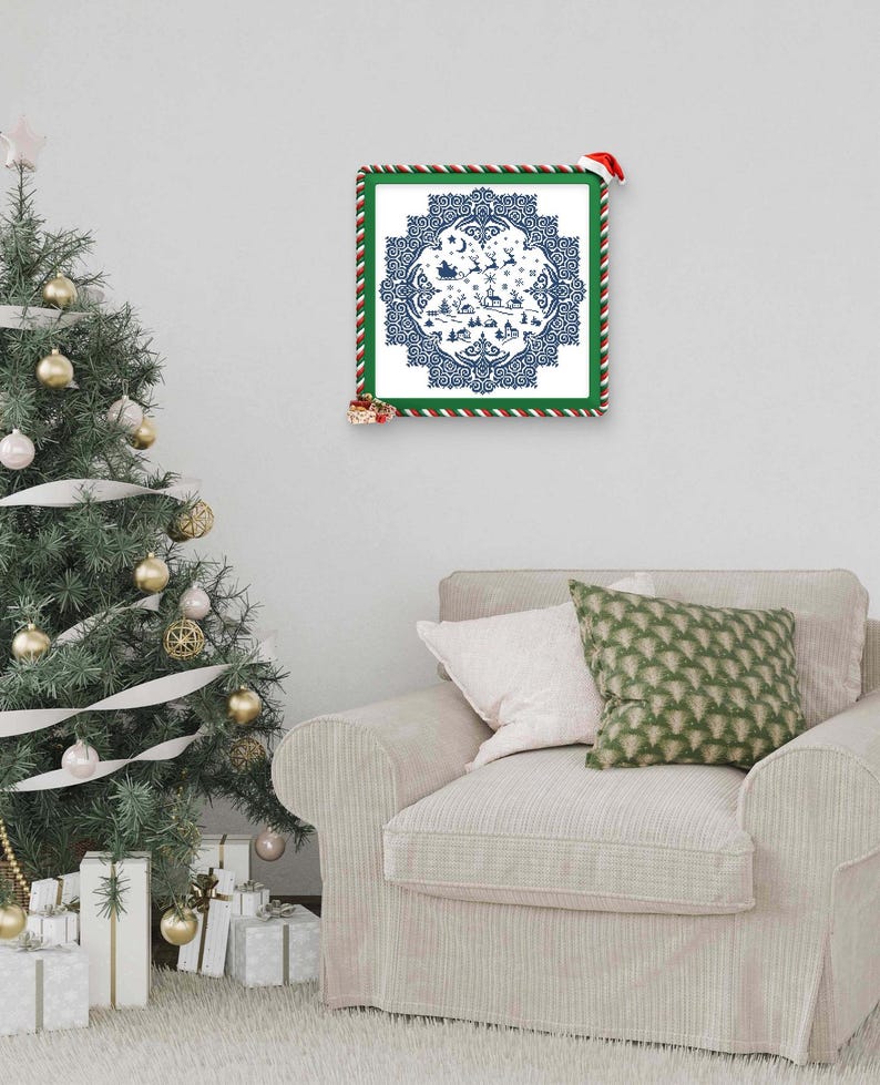 May include: A framed Christmas-themed print with a blue and white design featuring Santa's sleigh, reindeer, and a village scene. The frame is green with red and white striped trim. A Christmas tree and presents are in the background.