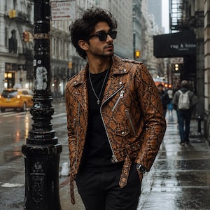 May include: A brown snakeskin-effect leather jacket with a silver zip and belt, worn over a black top and black trousers. The background shows a city street with a yellow taxi and street signs.