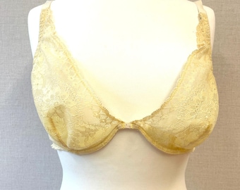May include: A yellow lace bra with adjustable straps and a hook and eye closure in the front.