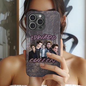 May include: A phone case featuring a forest scene with images of actors. The text "EDWARD CULLEN" is displayed in a purple font. The case is designed for a smartphone with multiple camera lenses.