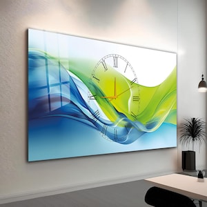 May include: Large wall clock with a modern design. The clock face has Roman numerals and orange hands. The background features blue and green abstract waves. The clock is mounted on a white wall.