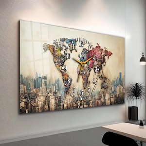 Op de afbeelding: Een grote rechthoekige wandklok met een wereldkaartontwerp. De kaart is gevuld met kleurrijke abstracte patronen tegen een beige achtergrond. De klokwijzers zijn goudkleurig en de cijfers zijn zwart.