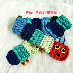 May include: A colorful, crocheted caterpillar toy in shades of blue, green, and red. The caterpillar has a segmented body, small legs, and a smiling face with yellow eyes. The text "PDF PATTERN" is visible.