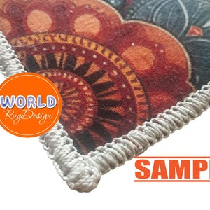 May include: Close-up of a rug corner with a detailed, colorful pattern in shades of red, orange, and blue. The rug has a white, braided border. The text "WORLD Rug Design" is in an orange circle, and the word "SAMPLE" is in the bottom right corner.