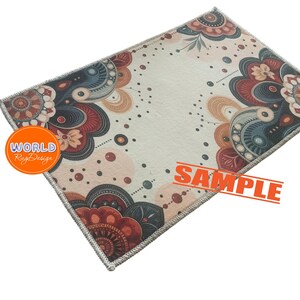 Puede incluir: Una alfombra colorida con un patr&oacute;n floral en tonos rojos, azules y marrones. La alfombra tiene un fondo blanco y un borde decorativo. El texto "WORLD Rug Design" es visible en la esquina inferior izquierda de la alfombra. El texto "SAMPLE" es visible en la esquina inferior derecha de la alfombra.