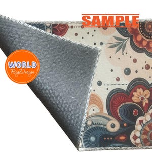 May include: A decorative rug with a floral design in shades of red, blue, and beige. The rug features a detailed pattern with a gray backing and the text "SAMPLE" and "WORLD Rug Design".