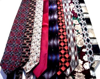 May include: A collection of ten patterned neckties in various colors, including red, blue, black, white, and brown. The ties feature geometric, floral, and abstract designs.