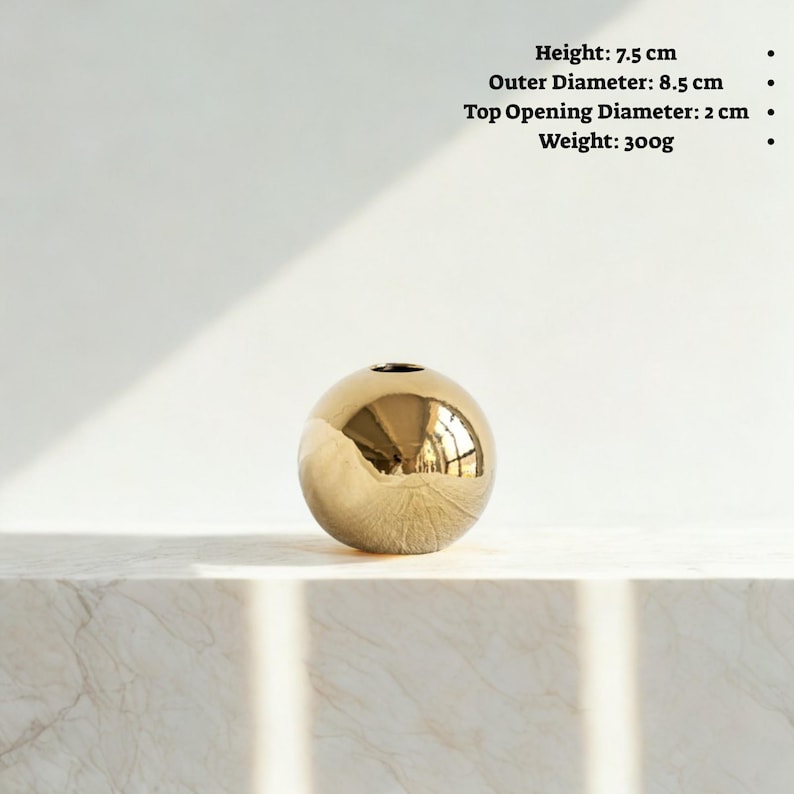 May include: A spherical, gold-colored vase with a small opening at the top. The vase is 3 inches tall, with an outer diameter of 3.3 inches. The top opening is 0.8 inches in diameter. The vase weighs 10.6 ounces.