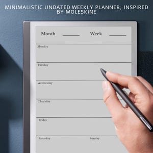 May include: A minimalist undated weekly planner, inspired by Moleskine, with a grey background. The planner has sections for the month and week, with lines for each day. A black stylus is held over the planner.