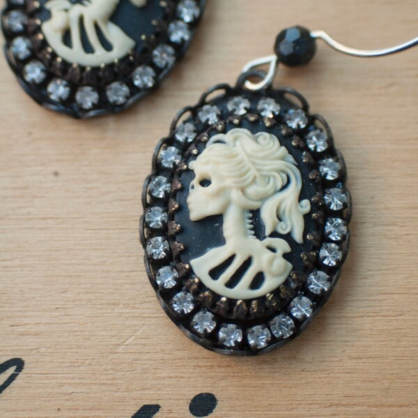 Skeleton earrings with rhinestones, brass bezels and faceted black stone on sterling silver ear wires.