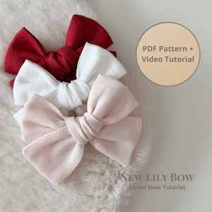 May include: Three linen bows in red, white, and pale pink are arranged on a fluffy, white surface. The bows are tied in the center with a classic bow shape. Text on the image reads "PDF Pattern + Video Tutorial" and "NEW LILY BOW Linen Bow Tutorial."