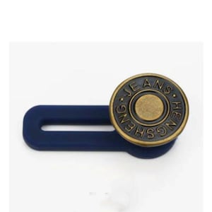 May include: A navy blue jean button extender with a circular, antique brass button. The button is embossed with the words "JEANS HENG SHENG" around the edge. The extender is a curved, elongated shape.