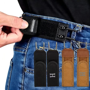 May include: Adjustable waist tightening straps for denim jeans, featuring black and tan fabric bands with metal hooks and hook-and-loop fasteners. The set includes two black straps, one with an H logo, and two tan straps, one with an H logo, shown attached to blue jeans.