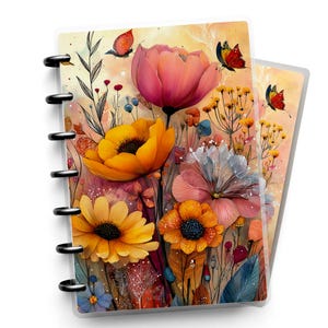 May include: A disc-bound notebook featuring a vibrant floral illustration on the cover. The design displays large pink, yellow, and orange flowers alongside delicate stems, leaves, and small butterflies against a soft, warm-toned background.