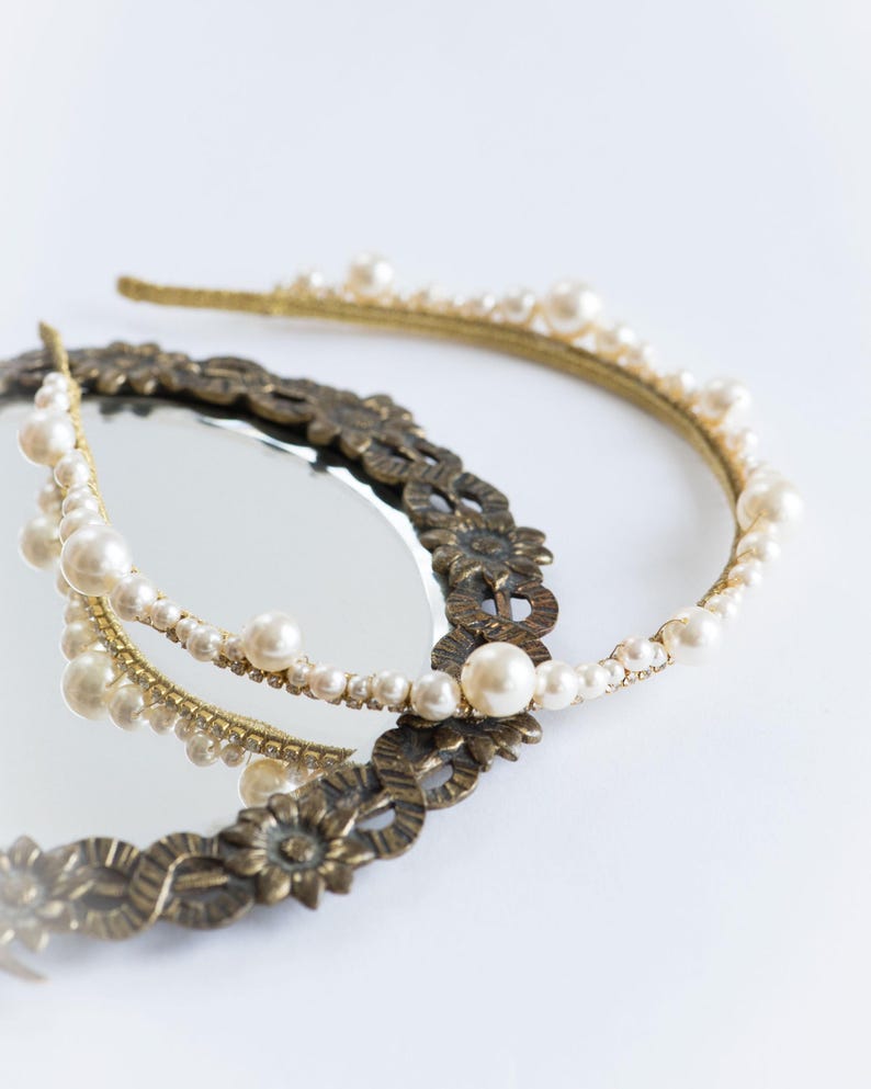 Large pearl headband with curved tiara silhouette.