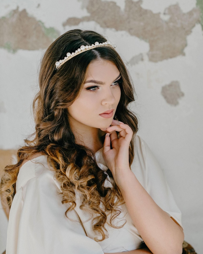 Scalloped pearl and crystal headband worn by bride.