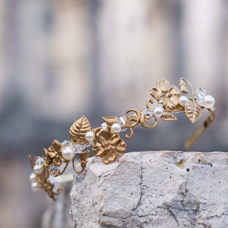 Edwardian inspired floral motif bridal headband photographed outdoors, brass flowers and pearl accents