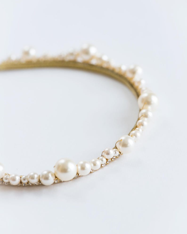 Large pearl headband with curved tiara silhouette.