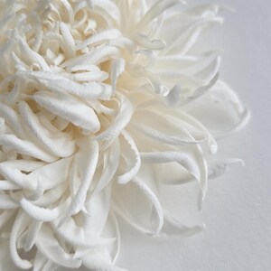 Close-up of handmade silk chrysanthemum petals shaped with millinery tools