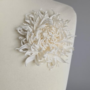 Chrysanthemum silk flower worn on mannequin as brooch