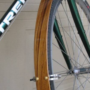 Front Teak wood bicycle fender.  Fender bolts onto the fork crown brake bolt hole and attaches to the fork drop outs with fender stays.