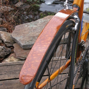 Rear bicycle fender hand made from super figured Leopard wood.  Great addition to fixed gear bikes to keep the spray off your back!