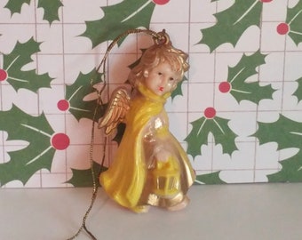 Vintage Germany Christmas angel carrying a lantern ornament plastic celluloid yellow and gold