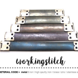May include: A collection of metal purse frame bars in varying shades of gray and blue, arranged in a stepped pyramid. Each bar has silver-colored end pieces. The text "workingstitch" is visible in a cursive font.