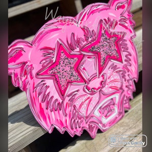 May include: Pink wooden cutout of a tiger's face with sparkly pink star-shaped sunglasses.