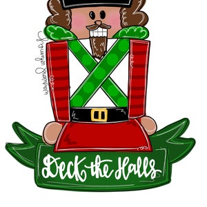 May include: A cartoon nutcracker with a red and white striped suit, green and white polka dot sash, and a black top hat. The nutcracker is holding a green banner with the text "Deck the Halls".