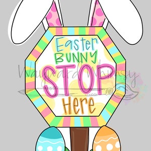 May include: A colourful Easter bunny stop sign with the text "Easter Bunny Stop Here" surrounded by yellow, pink, blue and green stripes. The sign is topped with white bunny ears with pink polka dots. Two Easter eggs, one blue and one orange, are at the base of the sign.