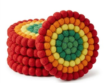 May include: A stack of circular coasters made from small, multi-colored felt balls. The coasters feature concentric rings of red, orange, yellow, and green felt spheres arranged in a dense, textured pattern, creating a vibrant, rounded design.